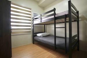 a bedroom with two bunk beds in a room at RSGH Staycation in Biñan