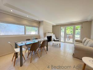 a living room with a table and chairs and a couch at Schinias Forest Beach House in Marathon