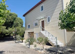 a building with stairs leading up to a door at Schinias Forest Beach House in Marathon