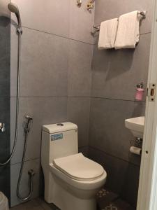 a small bathroom with a toilet and a sink at NIRVANA HAVEN HOME STAY in Trivandrum +28 photos