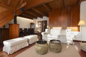 a living room with two white couches and a table at Mirador de Sallent by BeValle in Sallent de Gállego
