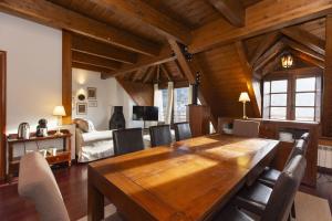 a dining room with a wooden table and chairs at Mirador de Sallent by BeValle in Sallent de Gállego