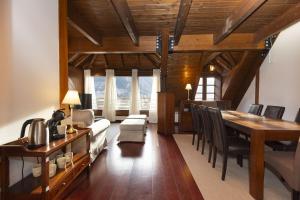 a living room with a dining room table and a dining room at Mirador de Sallent by BeValle in Sallent de Gállego