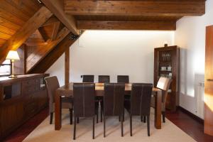 a dining room with a wooden table and chairs at Mirador de Sallent by BeValle in Sallent de Gállego +29 photos