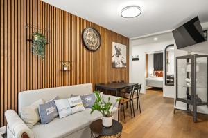 a living room with a couch and a table at BERG & BERG Apartments - Luzern Self-Check-in in Lucerne +21 photos