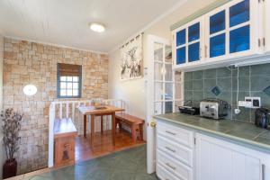 a kitchen with a counter and a table in it at Peace Valley Guesthouse in Napier