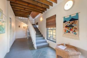 a hallway of a house with stairs and a window at Peace Valley Guesthouse in Napier