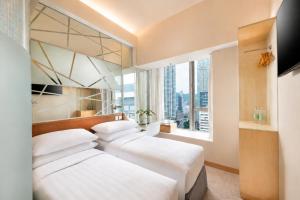 two beds in a hotel room with a window at Dorsett Mongkok, Hong Kong in Hong Kong +39 photos
