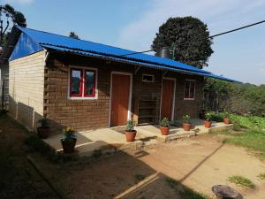 a small house with potted plants in front of it at Syangbo Homestay in Nagarkot