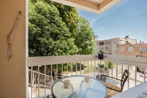 a balcony with a glass table and chairs on a balcony at Mila in Herceg-Novi