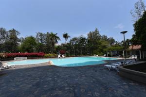 a large swimming pool with chairs around it at VIP CONDO RAYONG 343 in Rayong