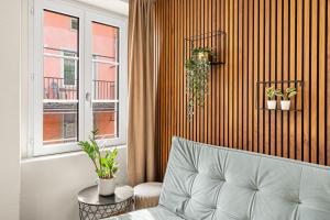 a living room with a couch and a window at BERG & BERG Apartments - Luzern Self-Check-in in Lucerne