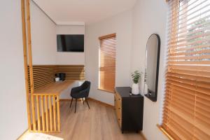 a room with a desk and a chair and a window at Amber Serviced Rooms - Free parking Self Check-In with access to shared kitchen in Hull
