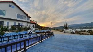 a building with a car parked in a parking lot at Namhae Tovhouse Pension in Namhae +17 photos