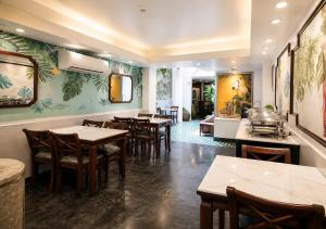 a dining room with tables and chairs in a restaurant at Halo Boutique Ben Thanh Hotel in Ho Chi Minh City