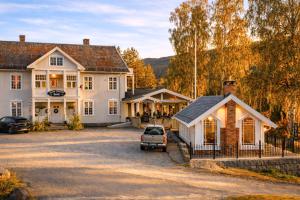 a house with a car parked in front of it at Eggedal Borgerstue in Eggedal