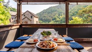 a table with plates of food on a balcony at Gapyeong The Hill Pool Villa in Gapyeong