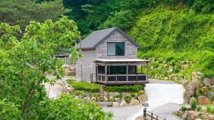 a house in the middle of a mountain at Gapyeong The Hill Pool Villa in Gapyeong +1 photo