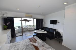 a living room with a couch and a table at VIP CONDO RAYONG 343 in Rayong