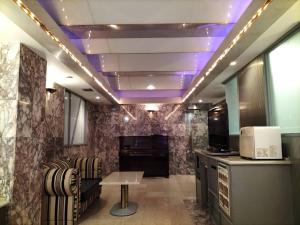 a room with a table and a purple ceiling at HotelG7 in Tokyo