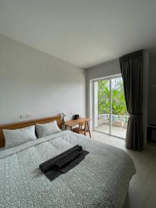 a bedroom with a bed with a robe on it at Hidden Bay Chaloklam in Chaloklum +36 photos