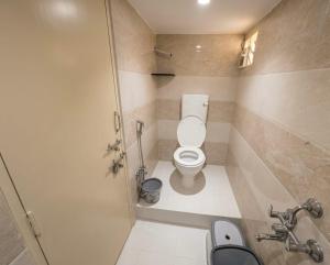 a small bathroom with a toilet and a sink at Hotel Prime Lodging in Aurangabad