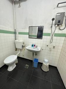 a bathroom with a toilet and a sink at planet hotel mersing in Mersing