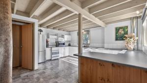 a kitchen with white cabinets and a large island at Coho in Dinner Plain