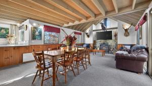 a dining room with a table and chairs at Coho in Dinner Plain