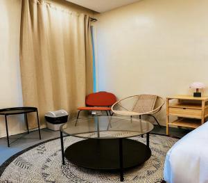a room with two tables and two chairs and a bed at The Ronin in General Luna
