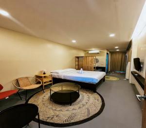 a bedroom with a bed and a table and chairs at The Ronin in General Luna
