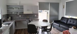 a kitchen and a living room with a table and a couch at Ingenia Holidays Hunter Valley in Cessnock