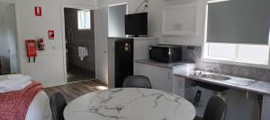 a kitchen with a sink and a table in a room at Ingenia Holidays Hunter Valley in Cessnock