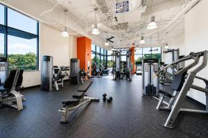a gym with several treadmills and cardio machines at Modern Luxury DC Free Parking in Arlington