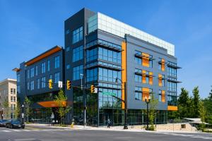 a tall building on a street corner with a traffic light at Modern Luxury DC Free Parking in Arlington