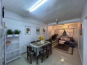 a living room with a table and a couch at D'Nas Homestay in Rawang