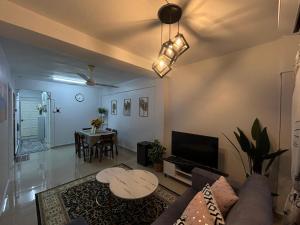 a living room with a couch and a table at D'Nas Homestay in Rawang