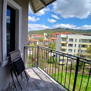 a balcony with a view of a building at Къща Рустик in Belogradchik