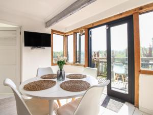 a dining room with a white table and chairs at West Island in Kingsbridge +29 photos