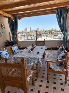 a room with a table and chairs and a large window at Zarhal boutique Premium in Bukhara