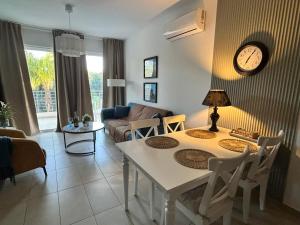 a living room with a table and a couch at Domino Blue Apartment in Paralimni