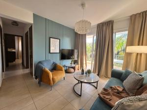 a living room with a couch and a table at Domino Blue Apartment in Paralimni