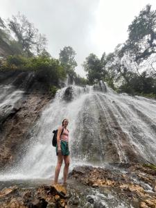 a woman standing in front of a waterfall at Youkata stay Hotel in Rampal