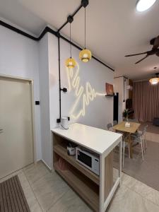 a living room with a white counter and a table at Pool View - H&A Signature Klebang in Malacca