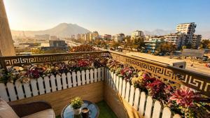 a balcony with a white picket fence and flowers at Royal Delegation Suite in Kabul