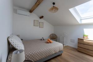 a bedroom with a bed and a skylight at Gite Goxa Leku in Ossès