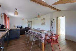a kitchen and dining room with a table and chairs at Gite Goxa Leku in Ossès