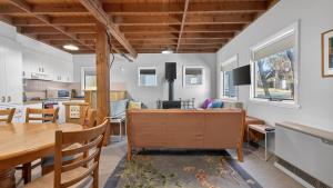 a kitchen and living room with a table and chairs at Feathertop in Dinner Plain