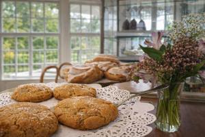 a table topped with cookies and a vase of flowers at Eggedal Borgerstue in Eggedal +35 photos