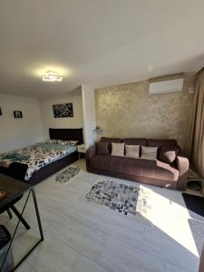 a living room with a couch and a bed at Casa Bon Relax , Rooms&Apartaments in Tuzla